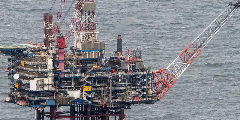 A close up of an oil platform on the ocean